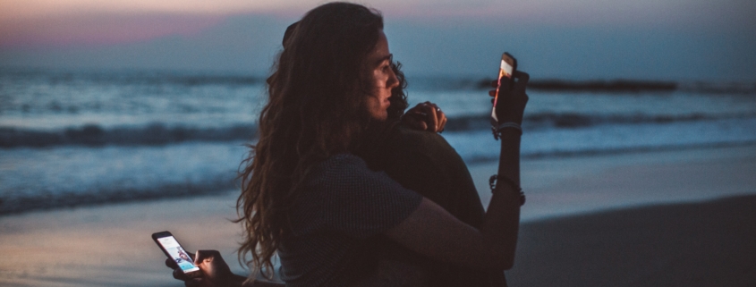 Couple isolates each other by looking at their phones